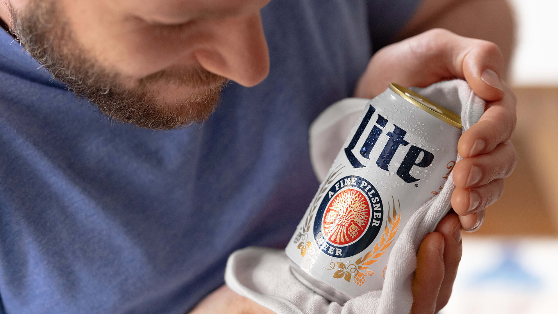 Man holding a Miller Lite as if it were a baby